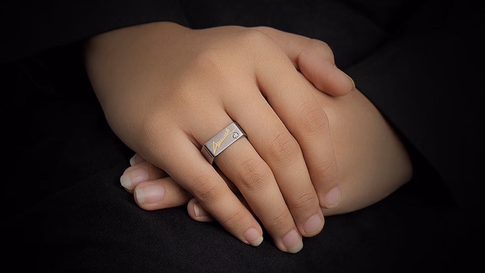 Close-up of a hand wearing an Autic World Autograph signet ring